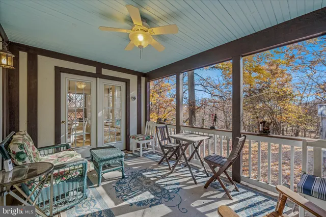 a view of a chair and tables in the balcony