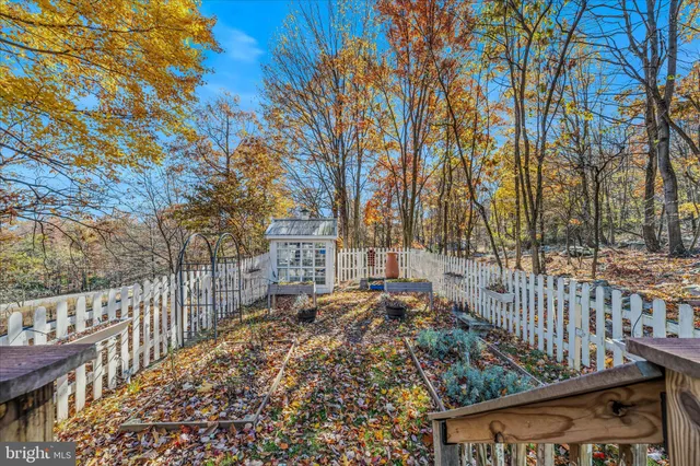 a view of a yard with wooden fence