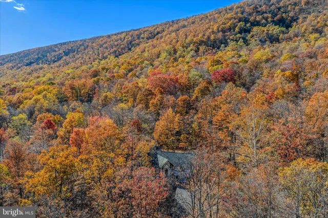a view of a large mountain with mountains in the background