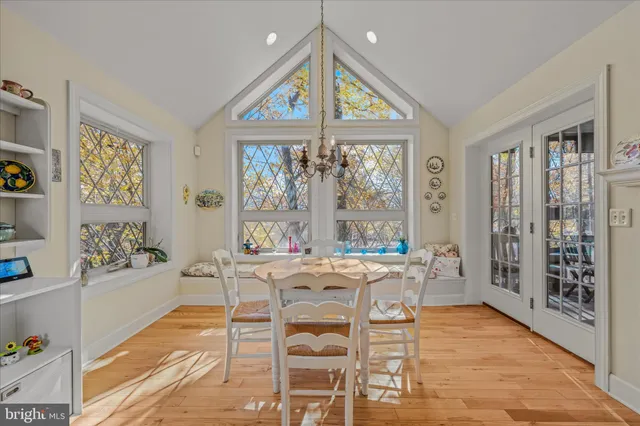 a view of a dining room with furniture and chandelier