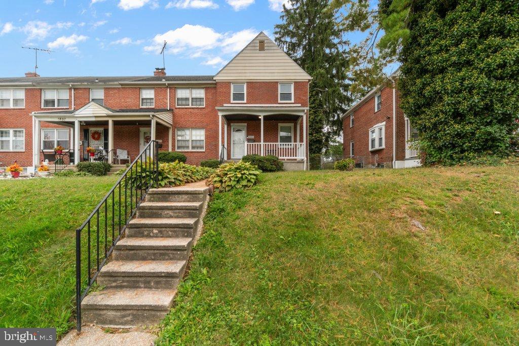 1633 Pentwood Road Baltimore, MD 21239 - Photo 2 of 33 Charming brick home with lush greenery.