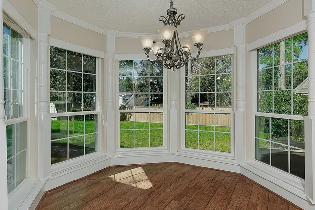 a view of a room with windows and wooden floor