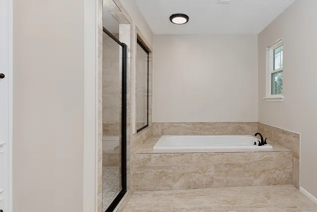 a bathroom with a tub and shower
