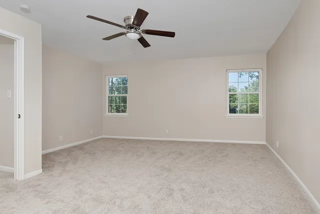 a view of empty room with ceiling fan