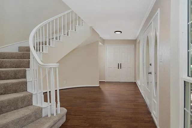 a view of an entryway with wooden floor
