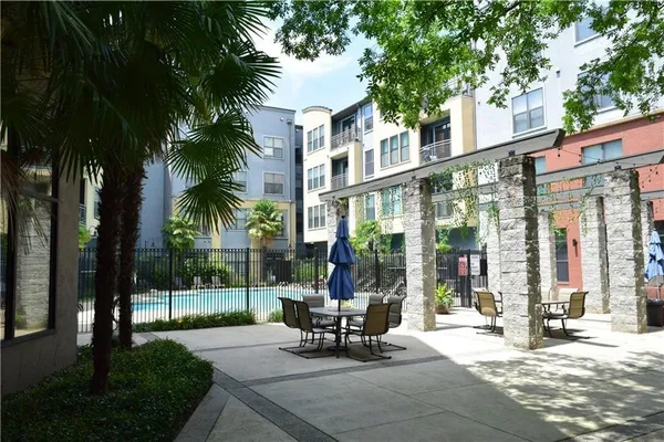 a view of a patio with a table and chairs