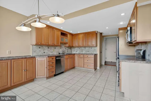 a kitchen with a sink cabinets and window