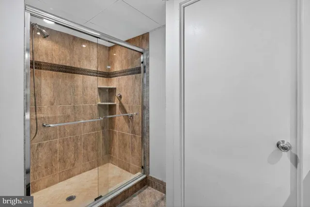 a bathroom with a glass shower door