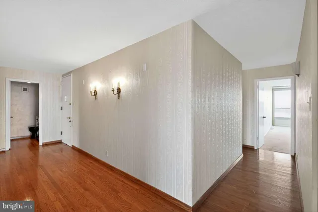a view of hallway with wooden floor