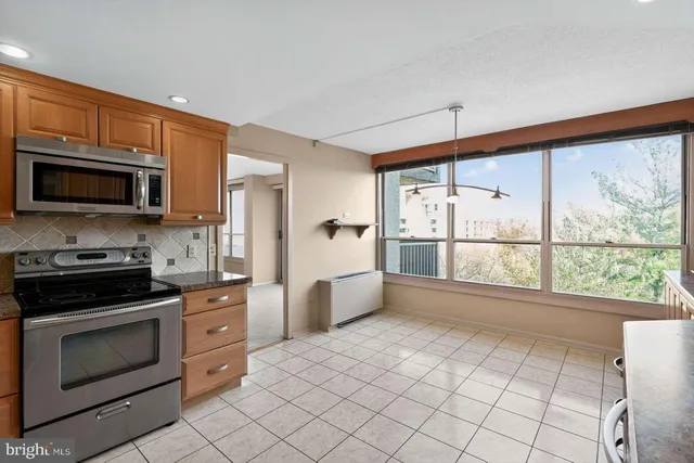 a kitchen with a stove a sink and a microwave