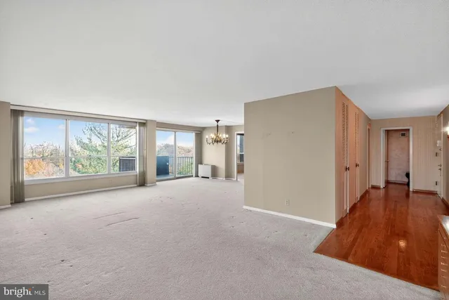 a view of a livingroom with an empty space and a window