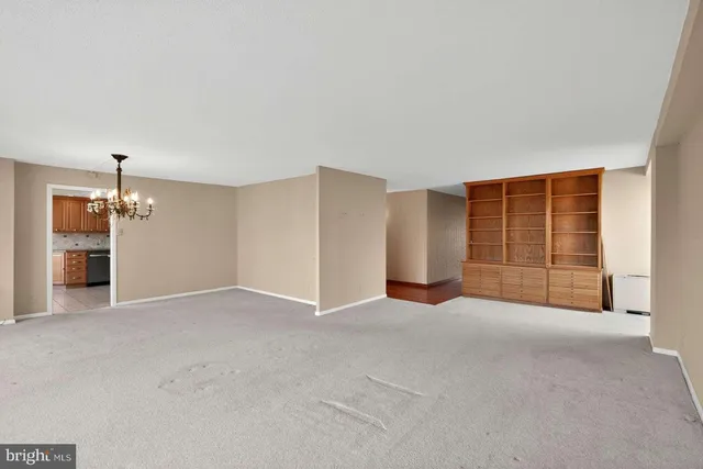 a view of an empty room with a kitchen
