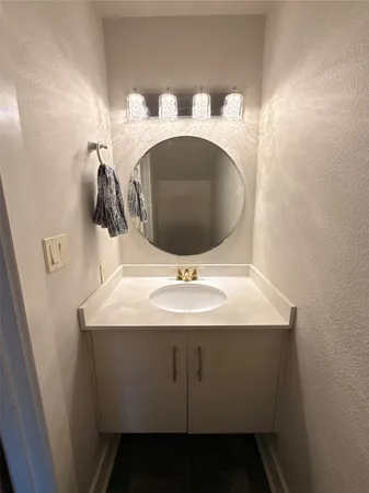 a bathroom with a sink and mirror