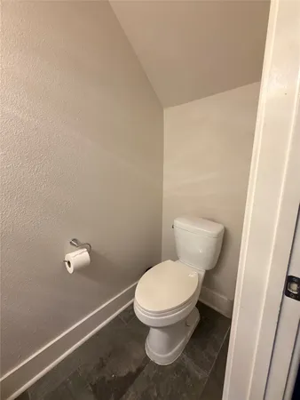 a white toilet sitting next to a shower
