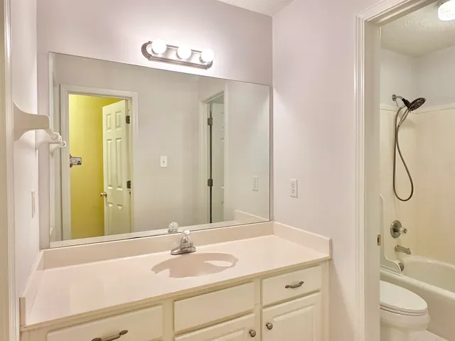 an empty room with a ceiling fan and a window