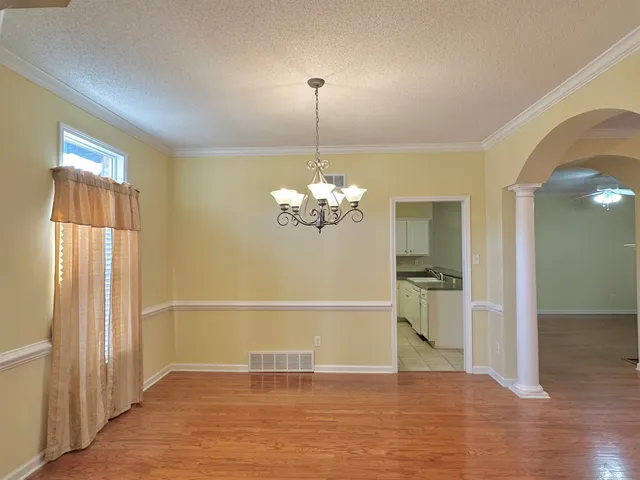 a view of a livingroom with a chandelier fan