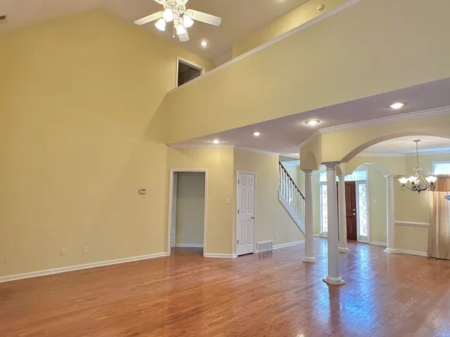 a view of an empty room with wooden floor