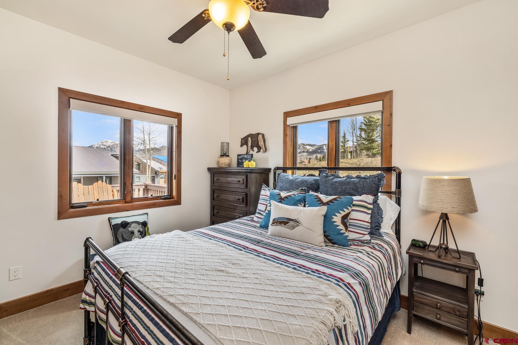 32 Cinnamon Mountain Road Crested Butte, CO 81225 - Photo 18 of 44 a bedroom with a bed and a large window