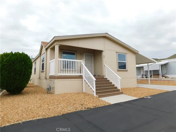 a view of house with backyard and deck