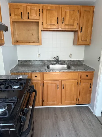 a stove top oven sitting inside of a kitchen