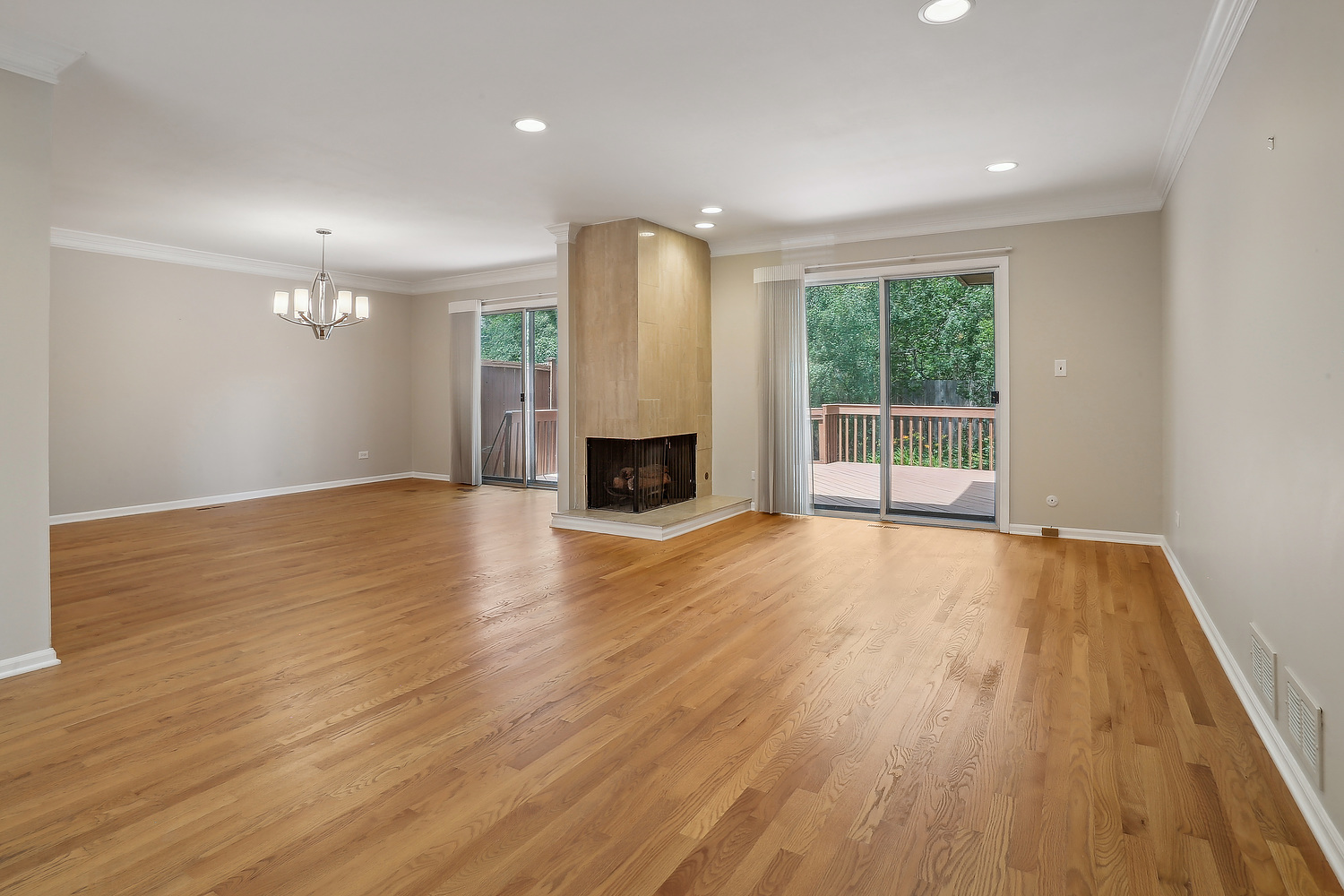 4010 Dundee Road Northbrook, IL 60062 - Photo 2 of 14 an empty room with wooden floor and fireplace