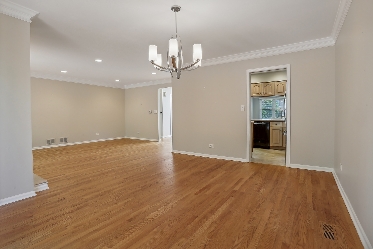 4010 Dundee Road Northbrook, IL 60062 - Photo 3 of 14 a view of an empty room with wooden floor and a window