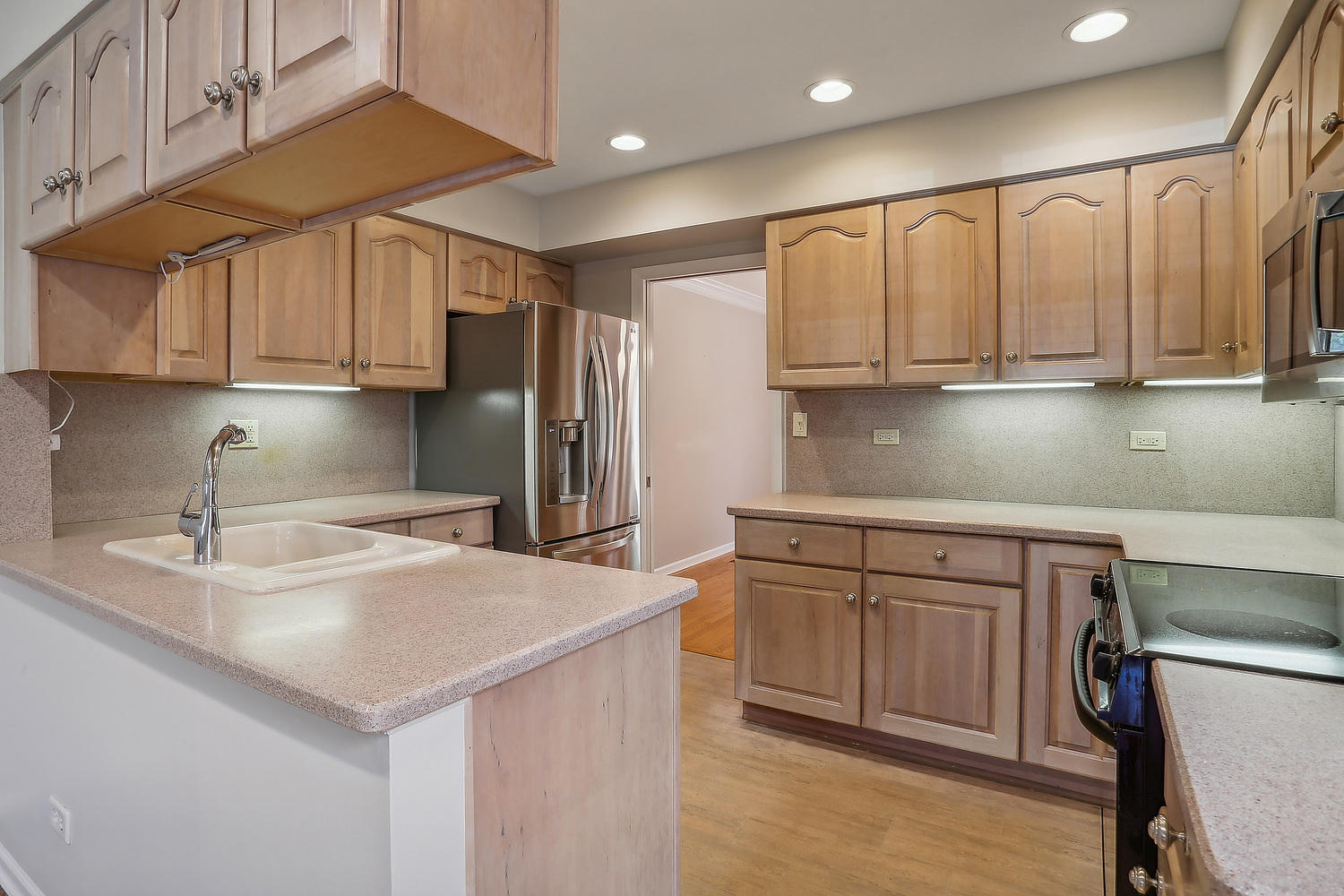 4010 Dundee Road Northbrook, IL 60062 - Photo 4 of 14 a kitchen with stainless steel appliances granite countertop a sink a refrigerator and a stove