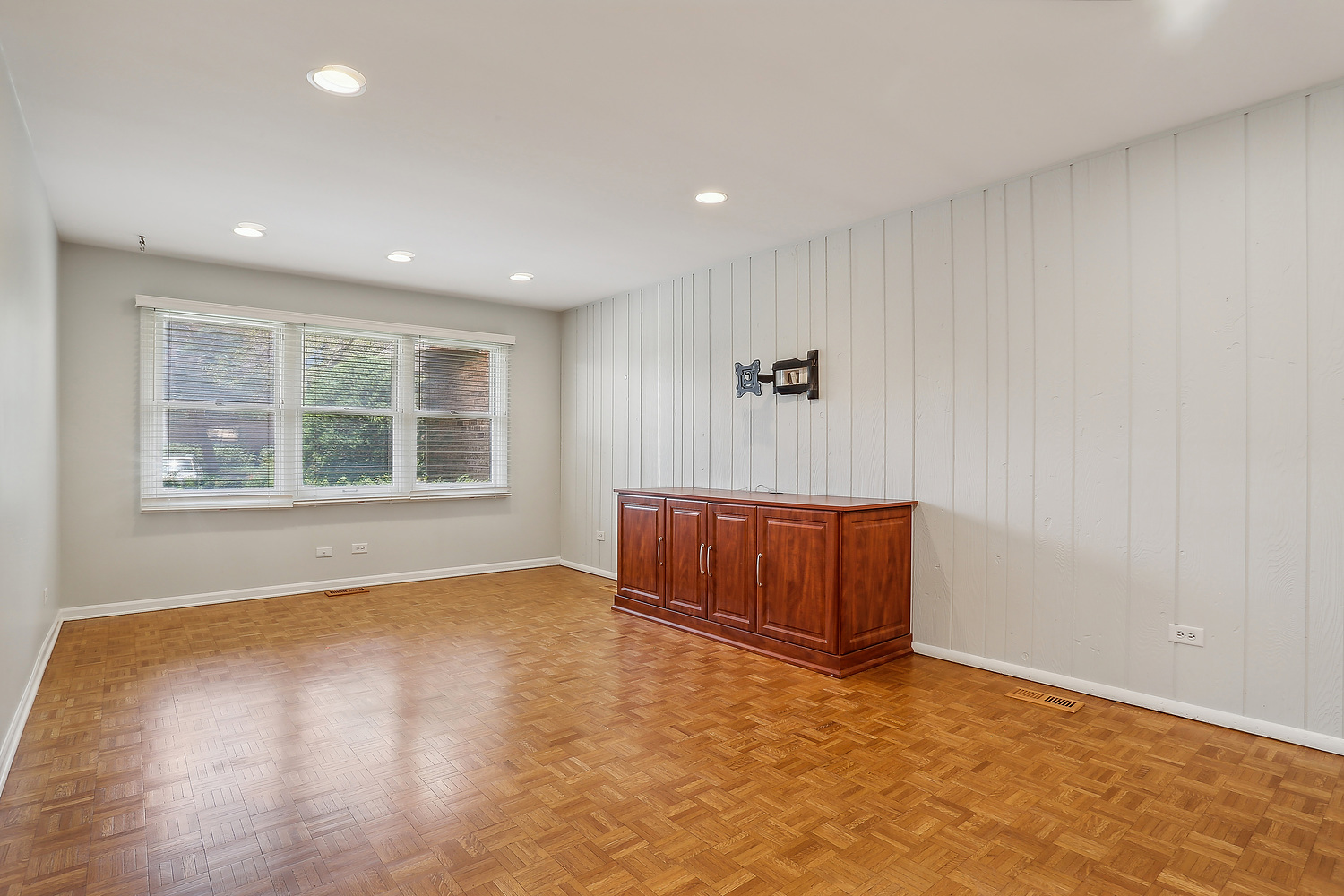 4010 Dundee Road Northbrook, IL 60062 - Photo 6 of 14 a view of an empty room with a window and wooden floor
