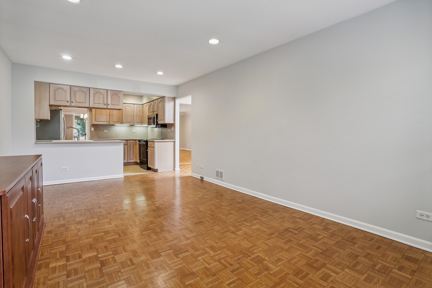4010 Dundee Road Northbrook, IL 60062 - Photo 7 of 14 a view of kitchen with kitchen island microwave and wooden floor