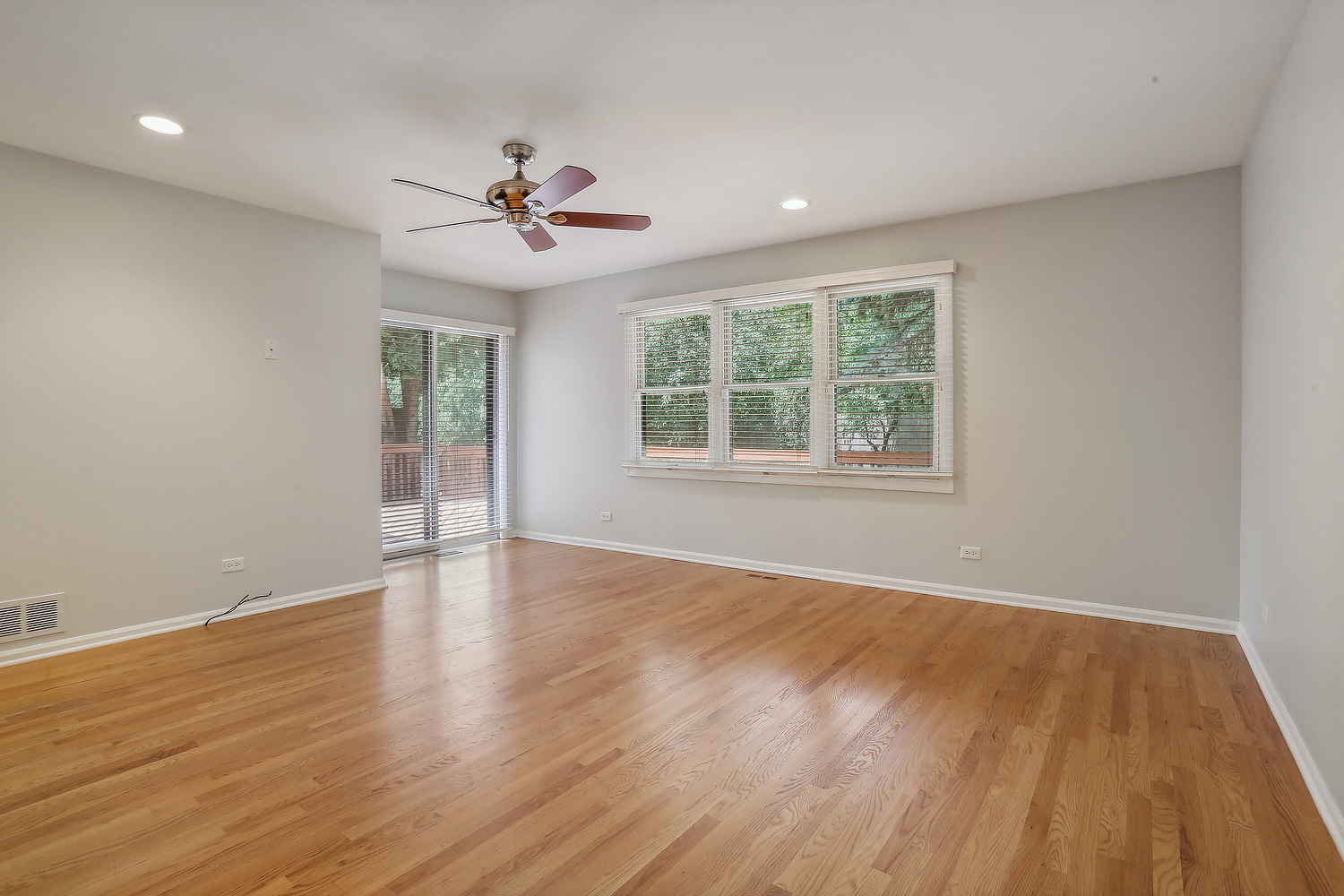 4010 Dundee Road Northbrook, IL 60062 - Photo 8 of 14 an empty room with wooden floor ceiling fan and windows