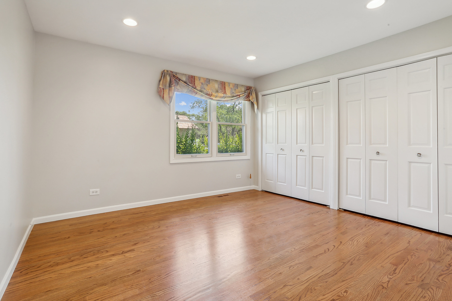 4010 Dundee Road Northbrook, IL 60062 - Photo 10 of 14 a view of an empty room with wooden floor and a window