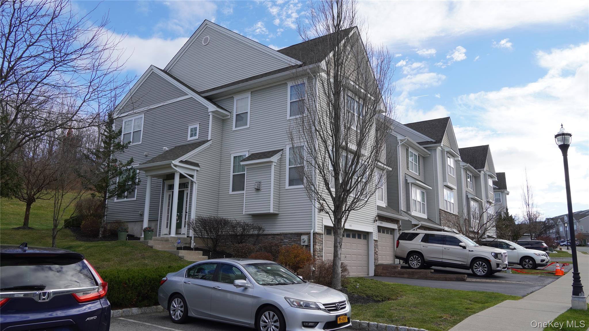 1402 Hawthorn Way New Windsor, NY 12553 - Photo 2 of 25 a car parked in front of a house