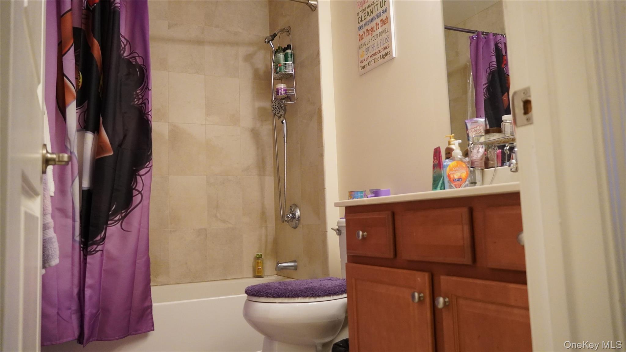 1402 Hawthorn Way New Windsor, NY 12553 - Photo 21 of 25 a bathroom with a toilet and a shower curtain