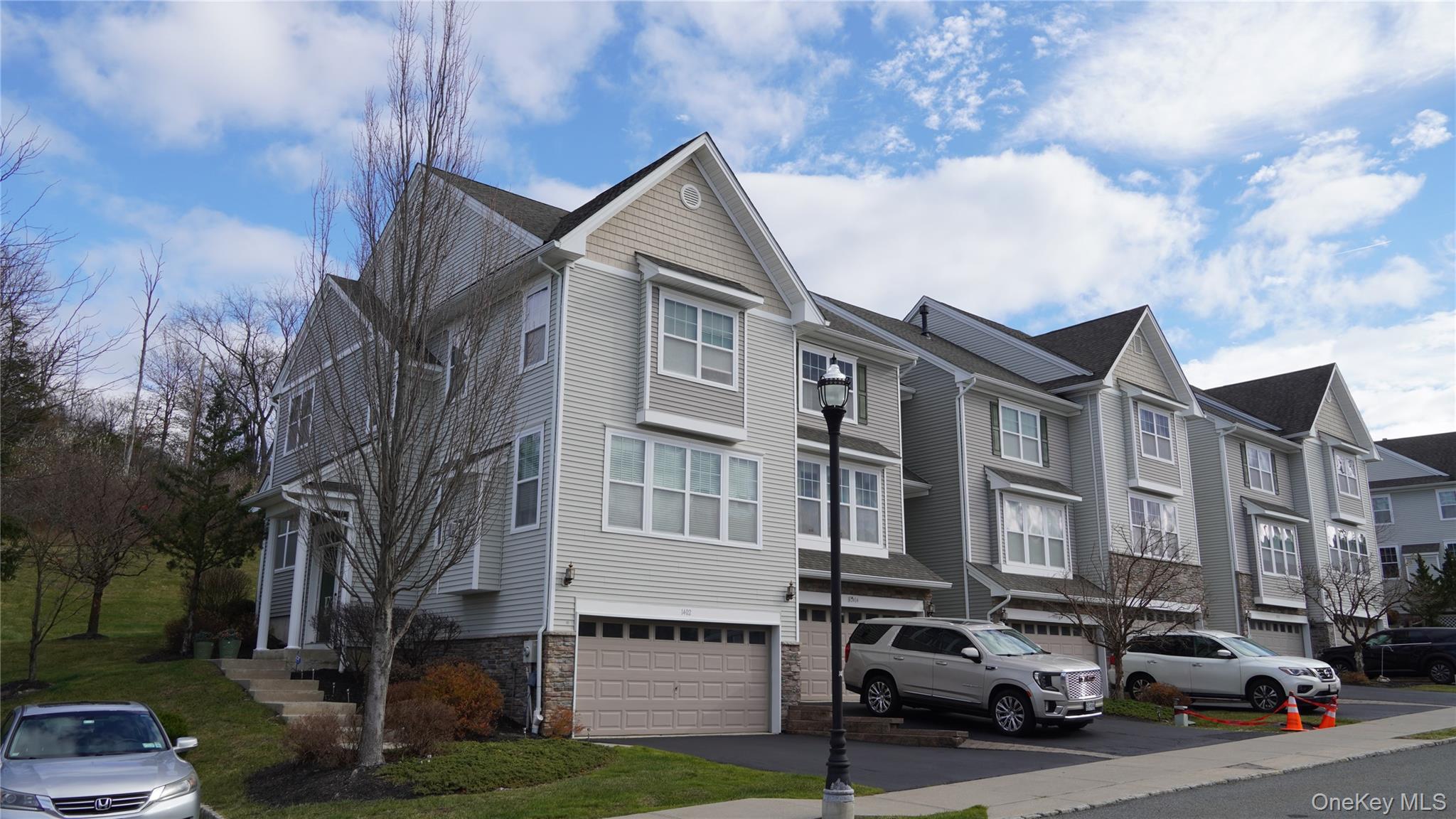 1402 Hawthorn Way New Windsor, NY 12553 - Photo 3 of 25 a city street lined with buildings and cars