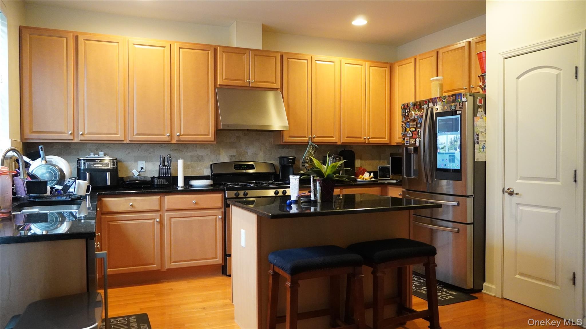 1402 Hawthorn Way New Windsor, NY 12553 - Photo 10 of 25 a kitchen with stainless steel appliances granite countertop a refrigerator a stove a sink dishwasher and white cabinets with wooden floor