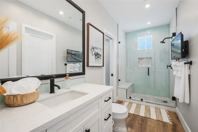 a spacious bathroom with a double vanity sink toilet and shower