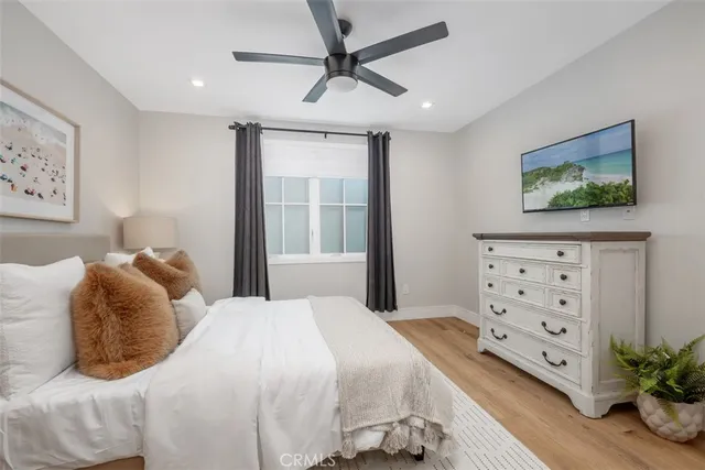 a bedroom with a bed and a painting on the wall