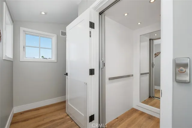 a view of hallway with wooden floor