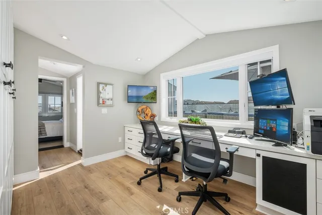 a view of a workspace with furniture and a kitchen