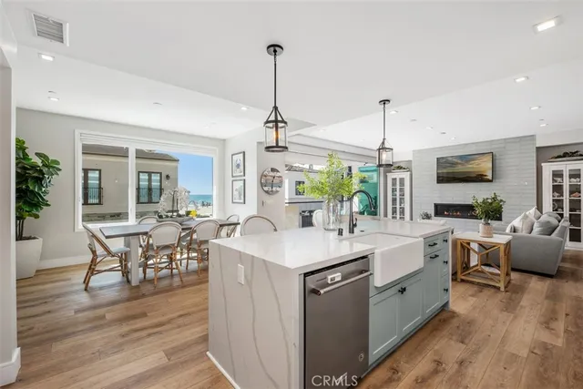 a kitchen with stainless steel appliances granite countertop a sink stove and wooden floor