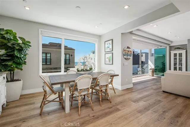 a dining room with furniture potted plants and wooden floor