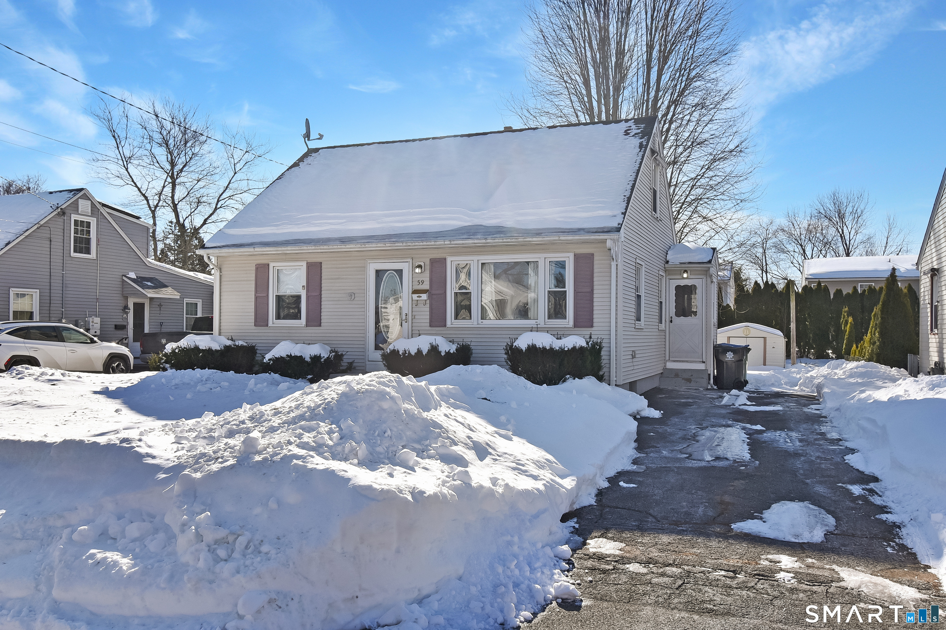 59 Maurice Street Bristol, CT 06010 - Photo 2 of 19 a view of a house with a yard covered in snow