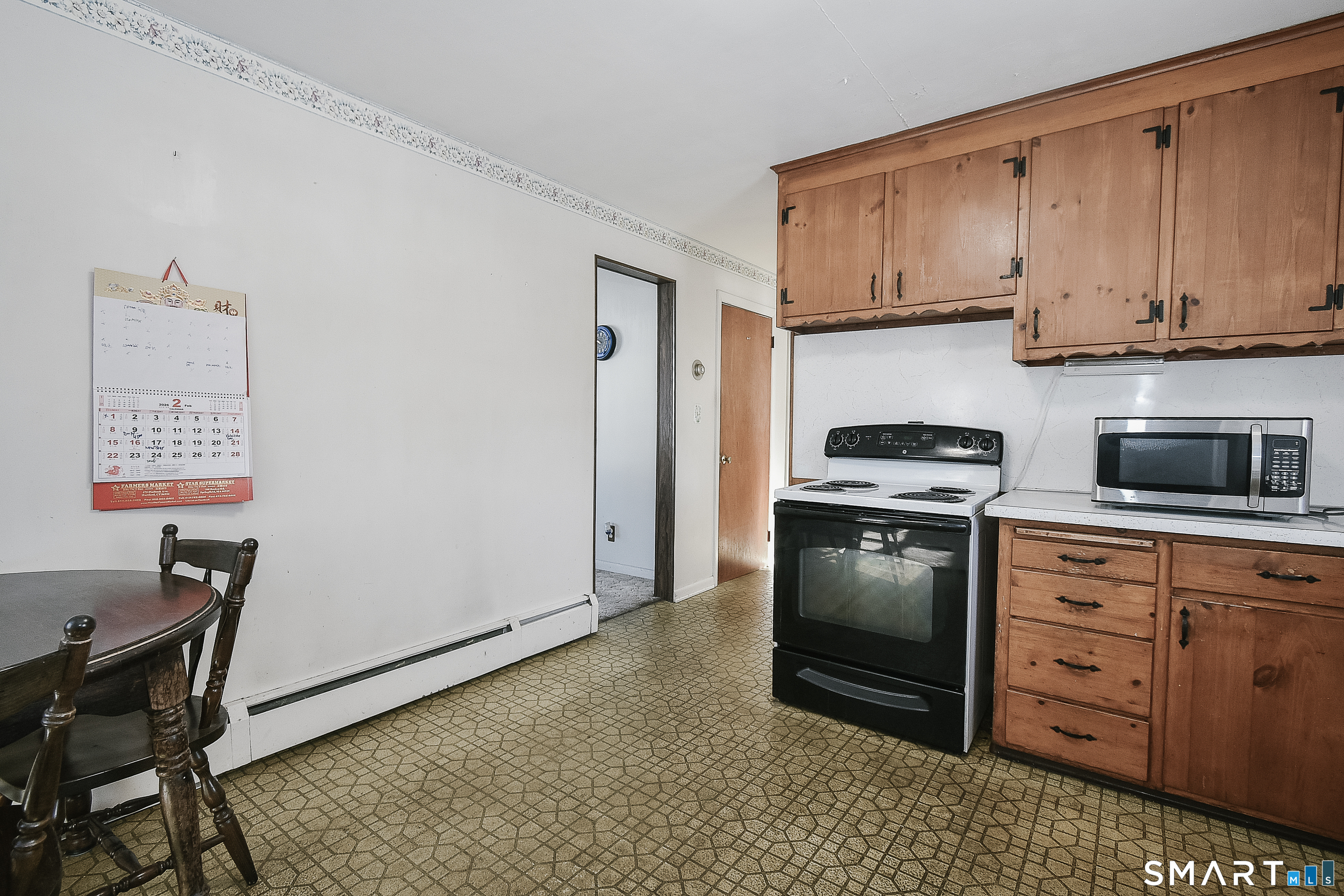 59 Maurice Street Bristol, CT 06010 - Photo 9 of 19 a kitchen with stainless steel appliances a stove a refrigerator and cabinets