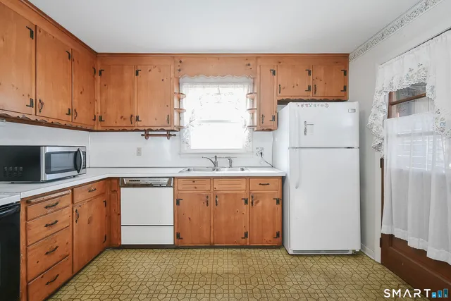 a kitchen with stainless steel appliances granite countertop a refrigerator sink and cabinets