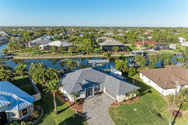 an aerial view of residential houses with outdoor space and swimming pool