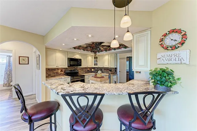 a kitchen with a sink stove and refrigerator