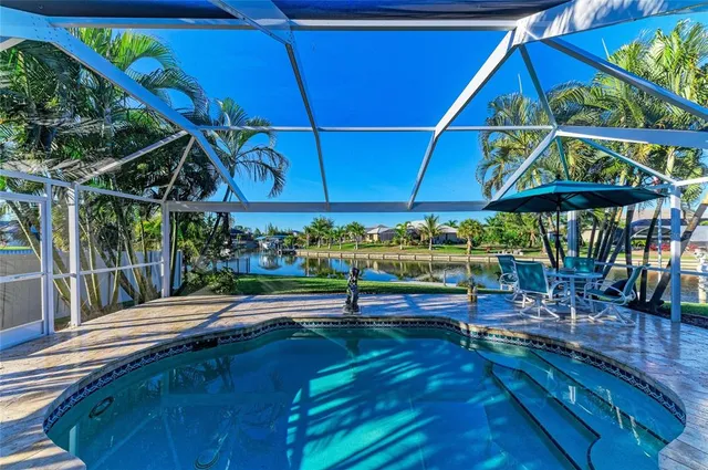 an aerial view of residential houses with outdoor space and lake view