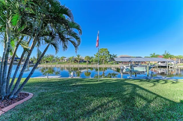 an aerial view of lake and residential houses with outdoor space