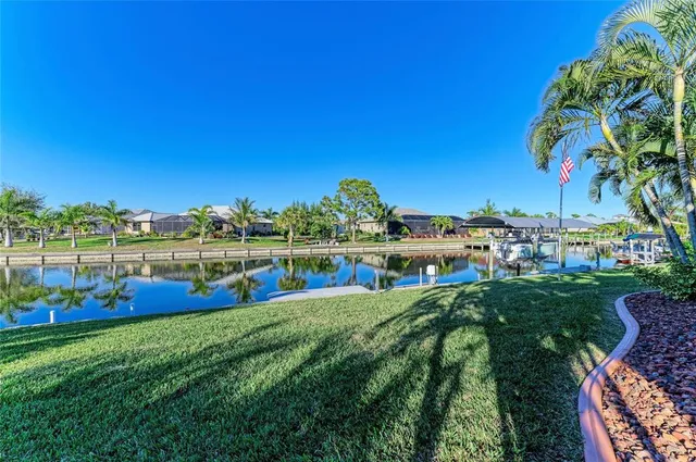 an aerial view of residential houses with outdoor space and lake view