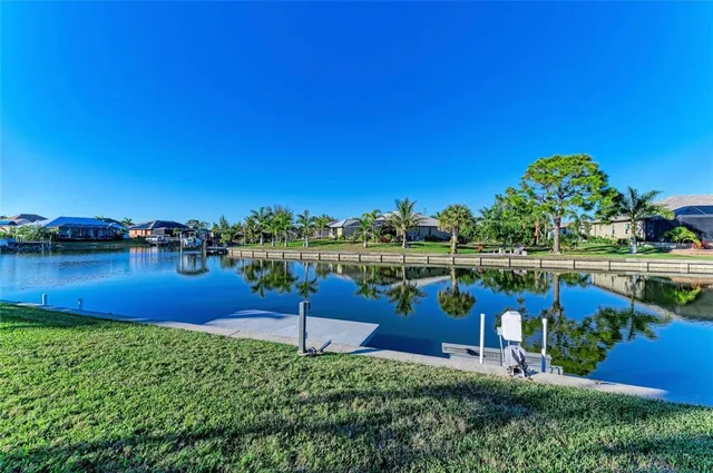 an aerial view of residential houses with outdoor space and lake view